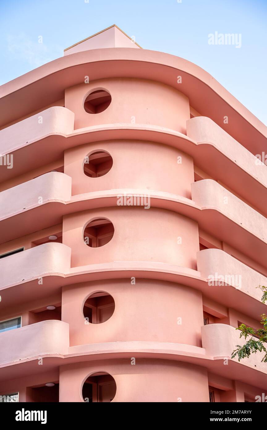 Honolulu, Hawaii - January 1, 2022: Exterior of a pink, retro art deco style apartment building in the heart of Waikiki. Stock Photo