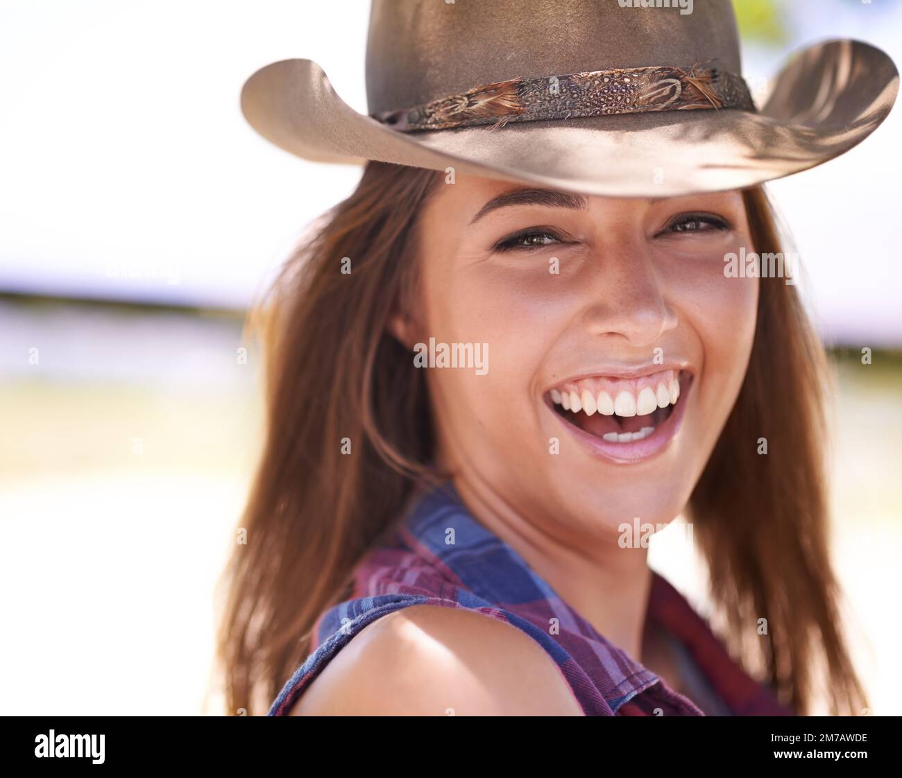 Do it right or get off the horse. A beautiful cowgirl standing outdoors. Stock Photo
