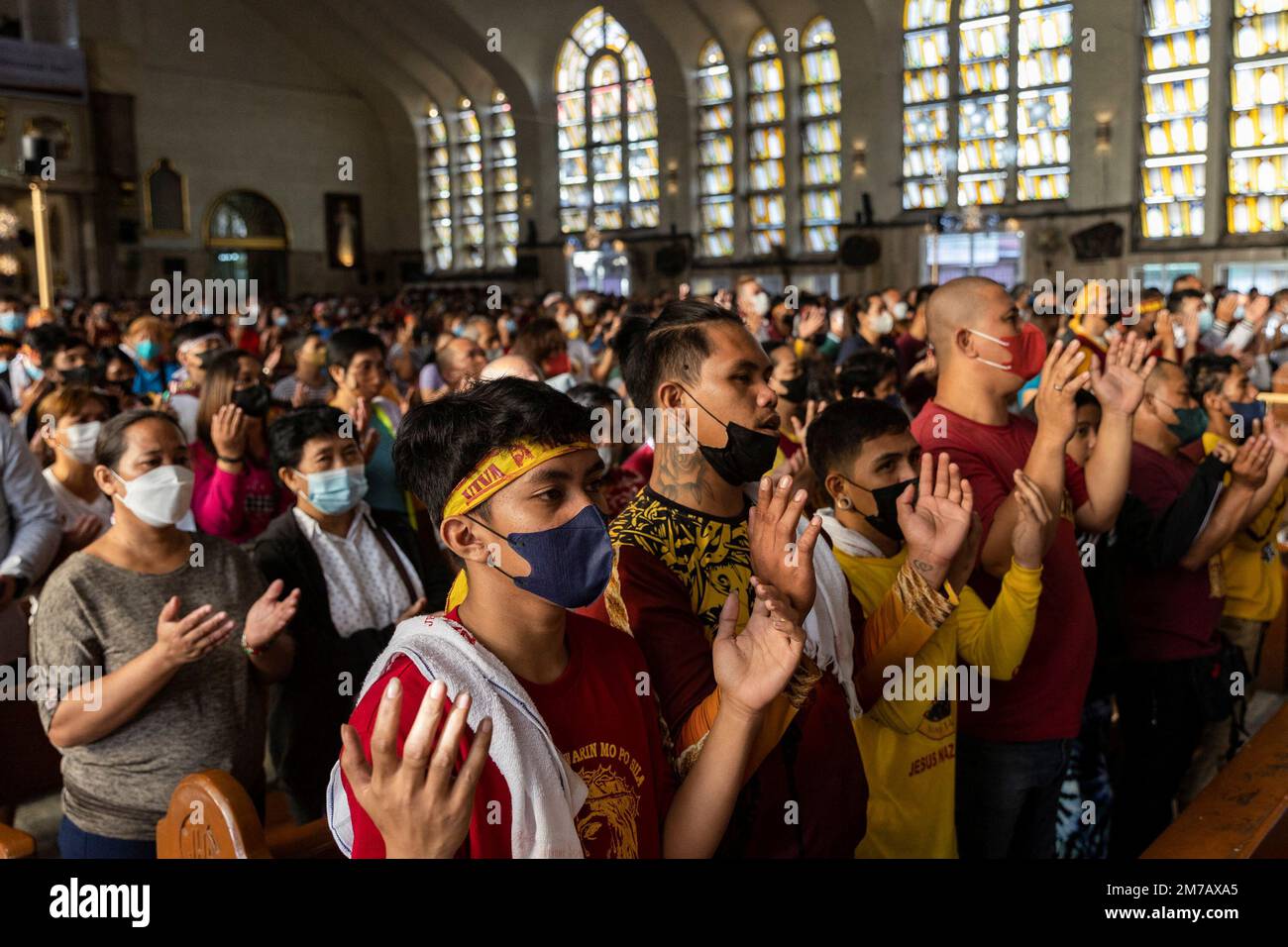 Filipino Catholic devotees attend mass during the feast day of the