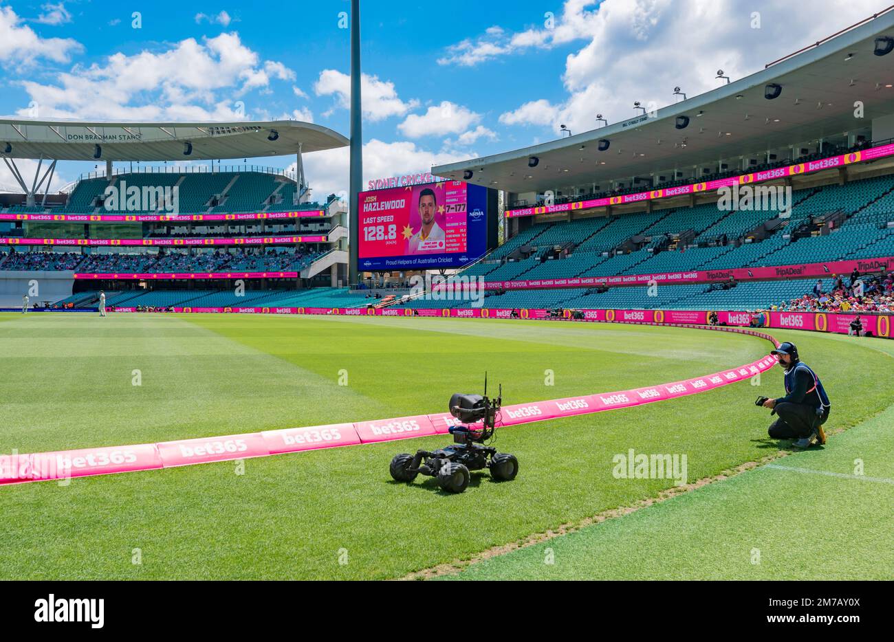 An outside broadcast television cameraman and remote controlled camera recording play at the 3rd Cricket Test Match between Australia and South Africa Stock Photo