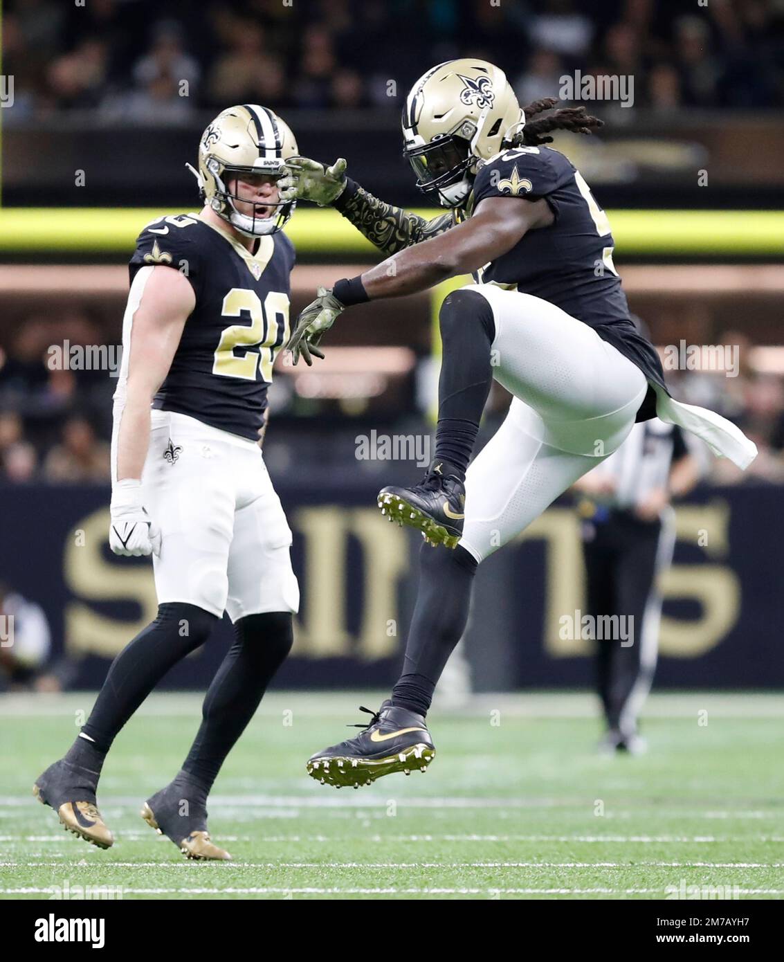 New Orleans Saints linebacker Pete Werner (20) watches fellow linebacker  Demario Davis (56) celebrate after making a huge play during a National  Football League contest at Caesars Superdome in New Orleans, Louisiana