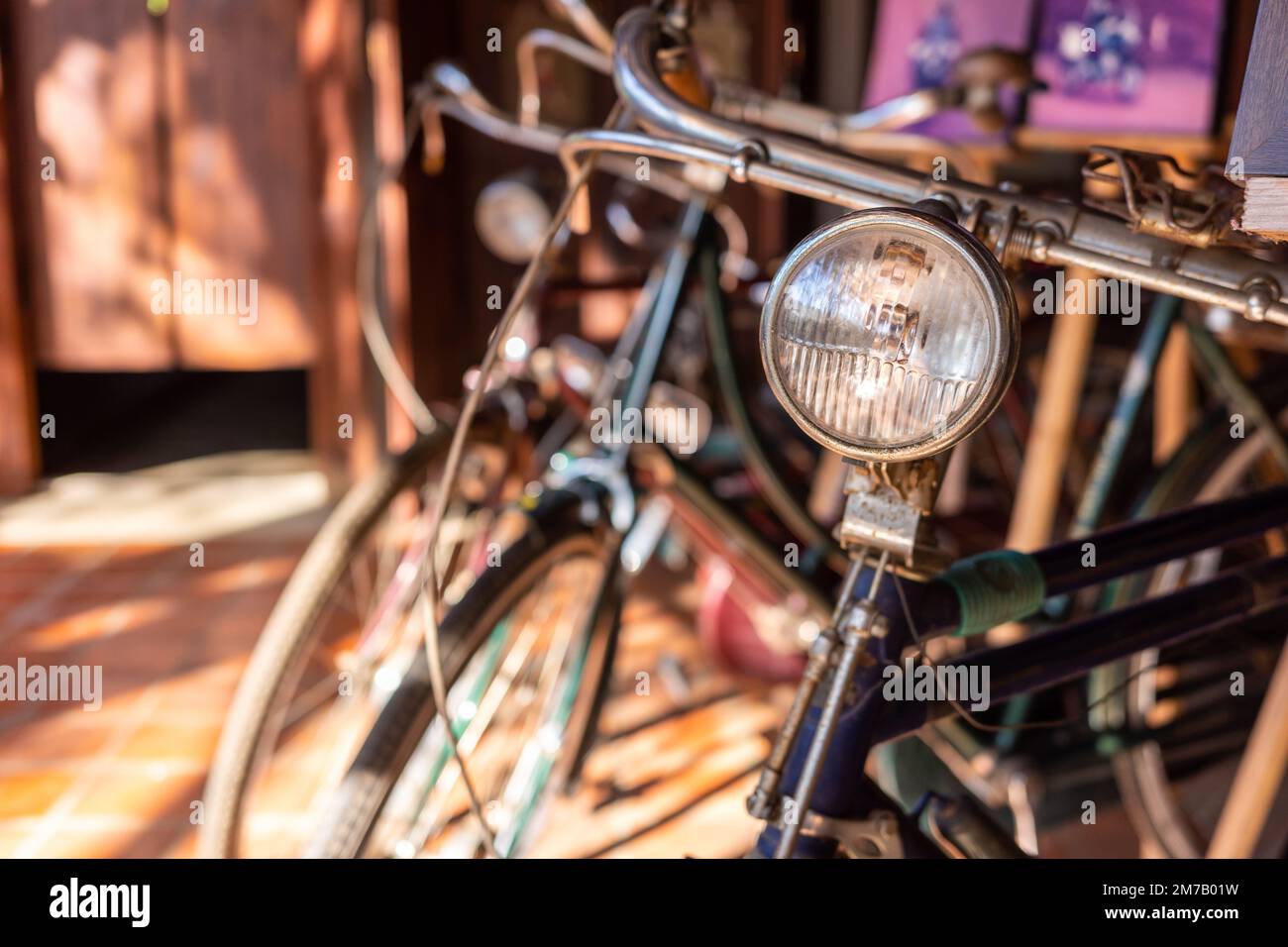 Close up on bike headlight with blurry background of other vintage and