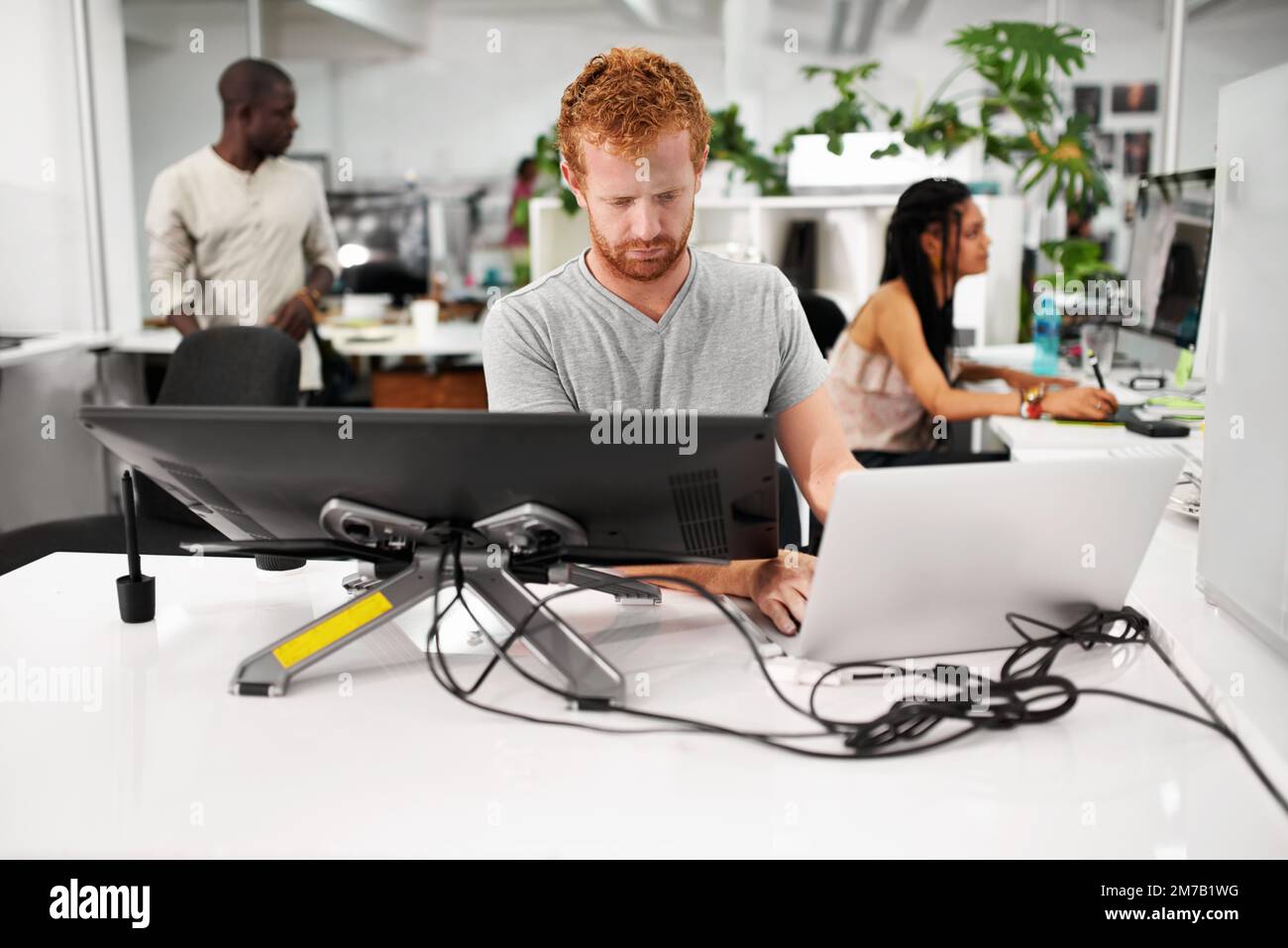 Smart technology makes everything easier. A young man working on a large touchscreen. Stock Photo