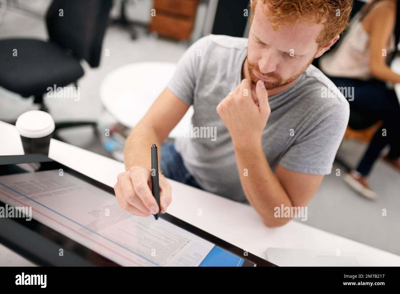 Smart technology makes everything easier. A young man working on a large touchscreen. Stock Photo