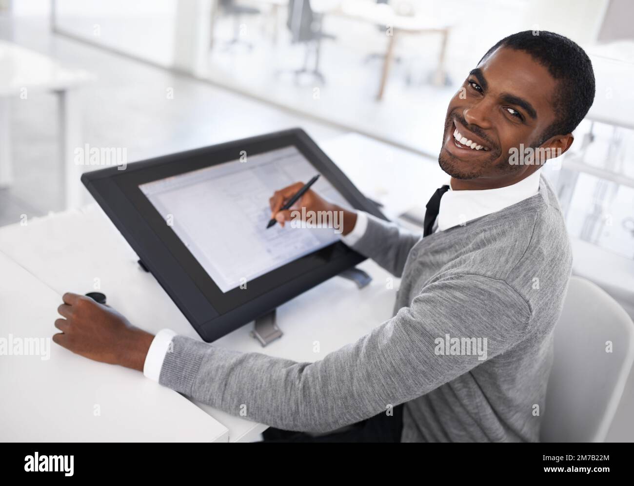 Smart technology makes everything easier. A young man working on a large touchscreen. Stock Photo