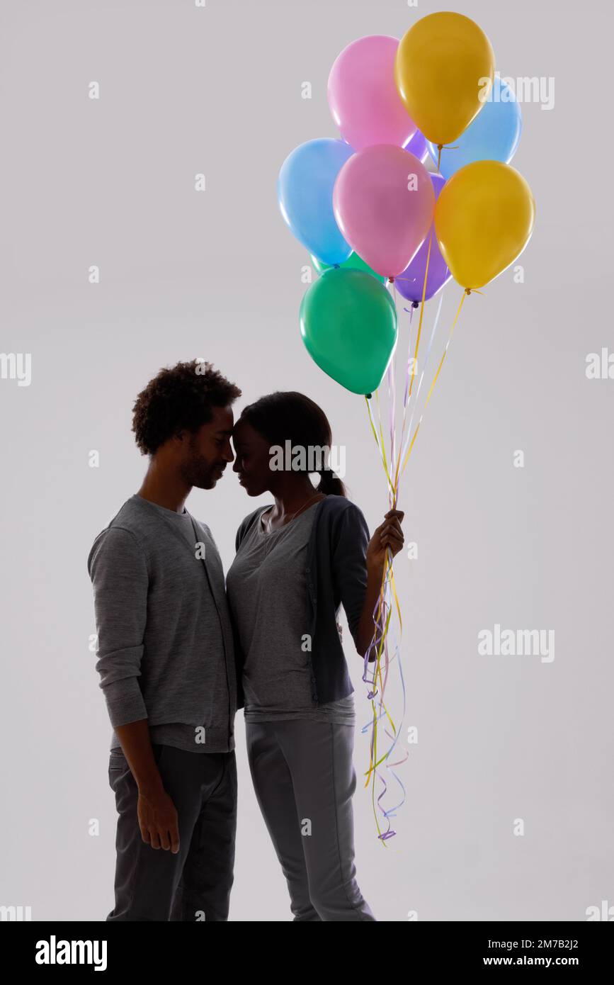 Romantic couple holding balloons hi-res stock photography and images ...