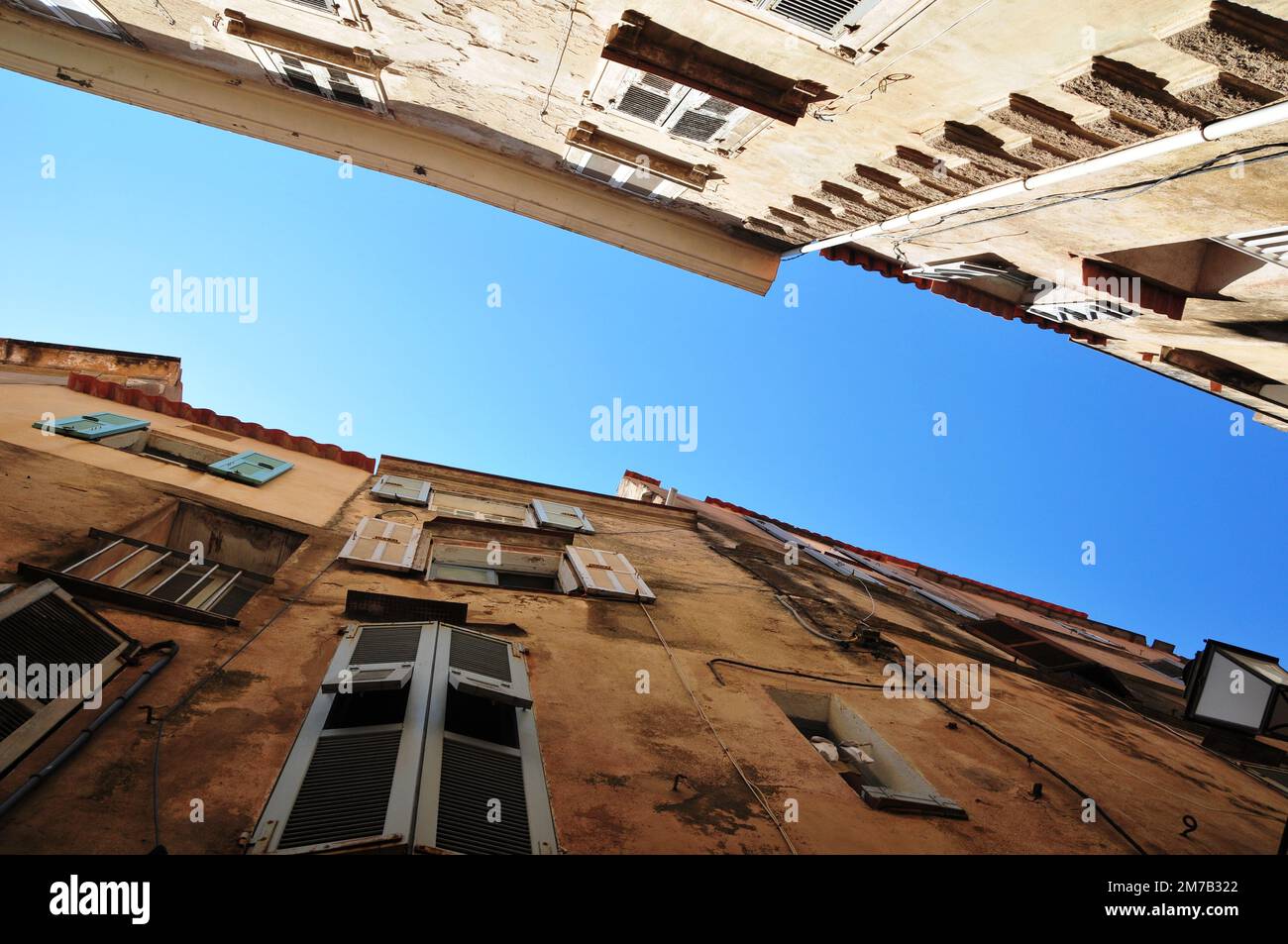 A low angle of residential buildings under a clear blue sky Stock Photo ...