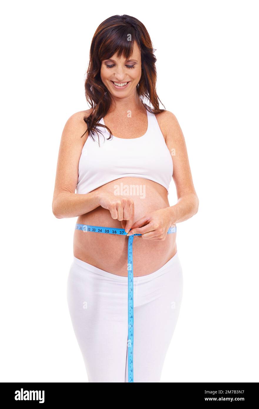 This little guy is growing. An expectant mother measuring her belly. Stock Photo