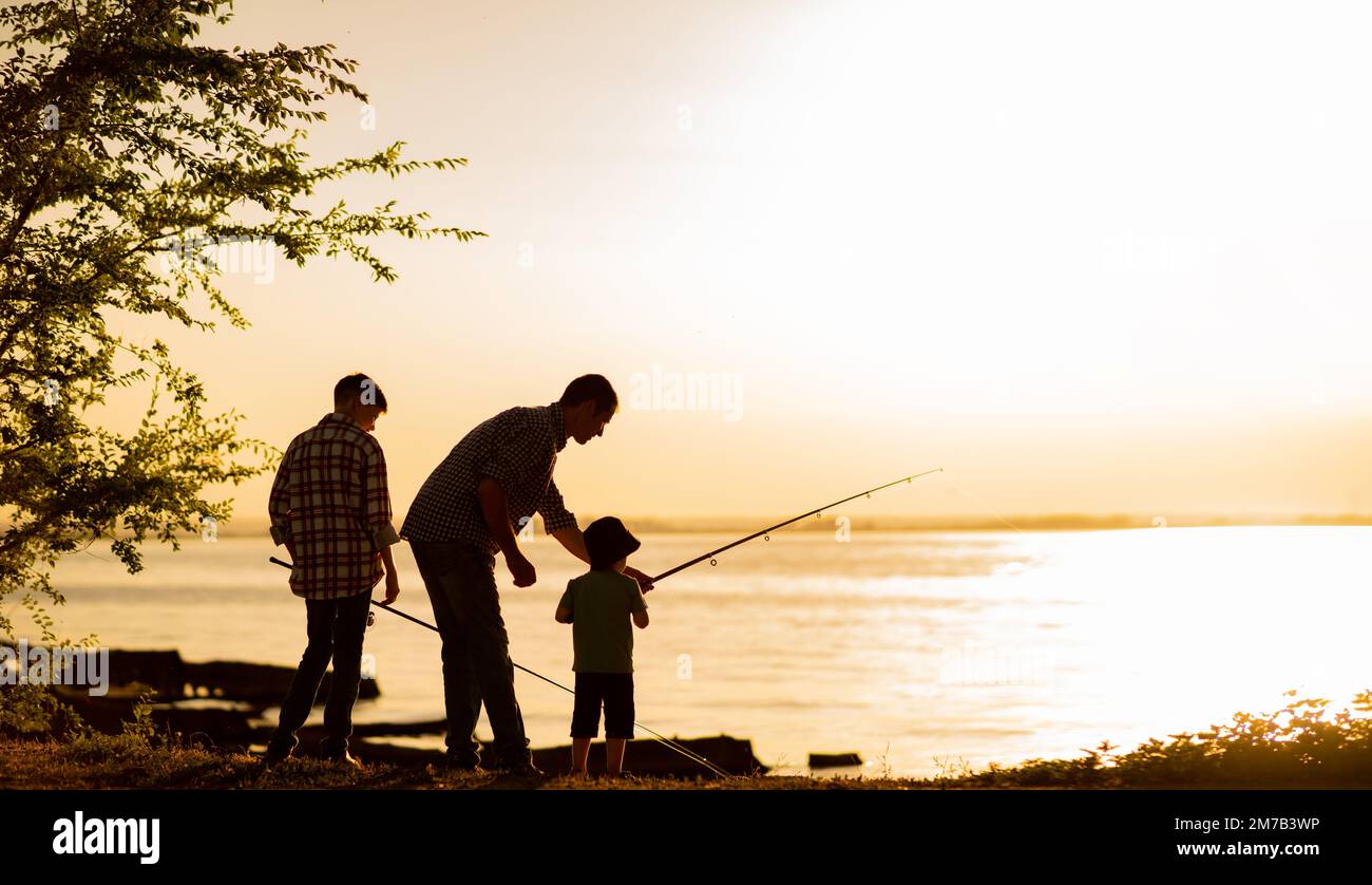 Silhouette of boy fishing hi-res stock photography and images - Alamy
