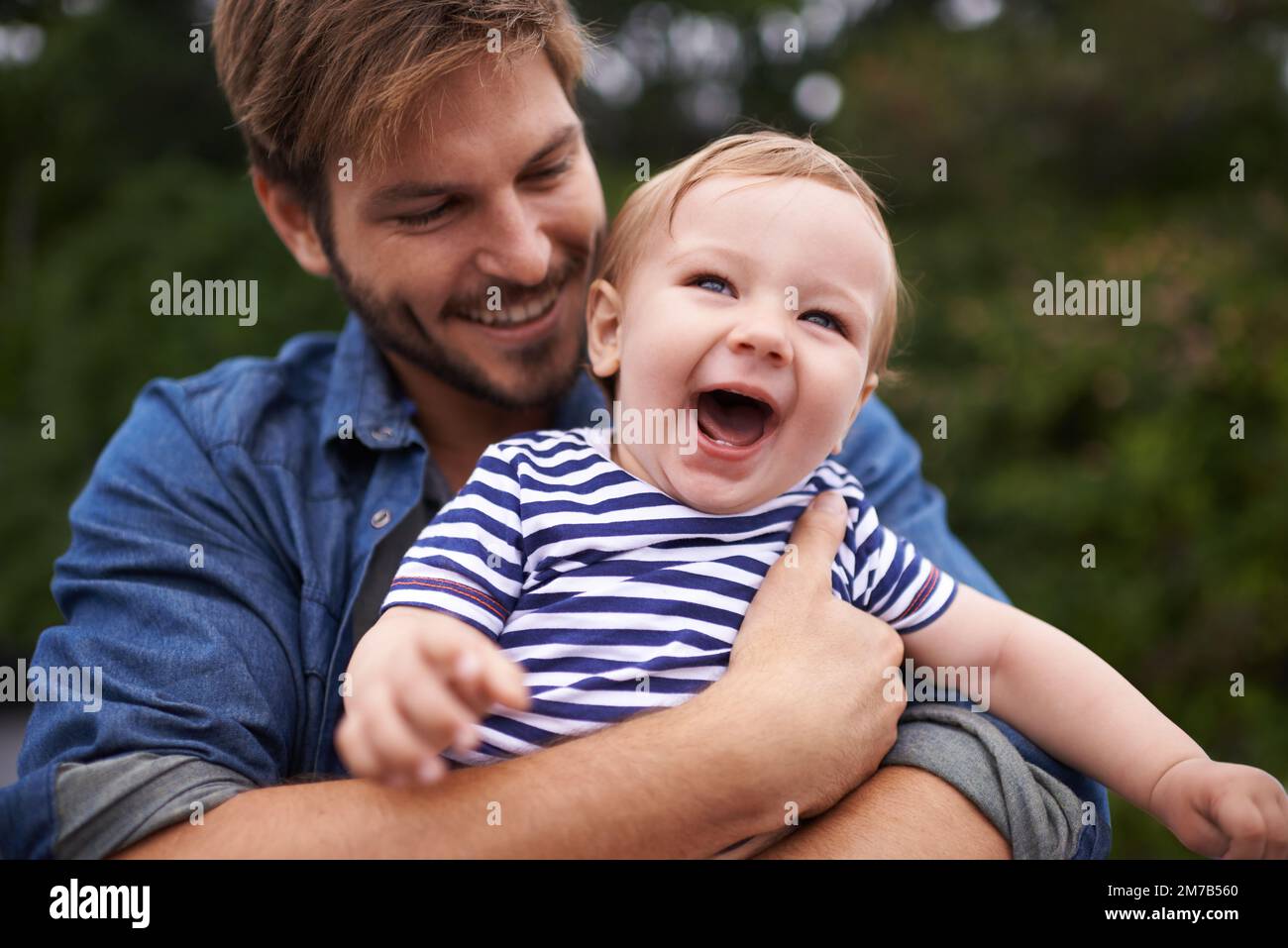 Enjoying the outdoors. young father and his baby boy enjoying a day ...