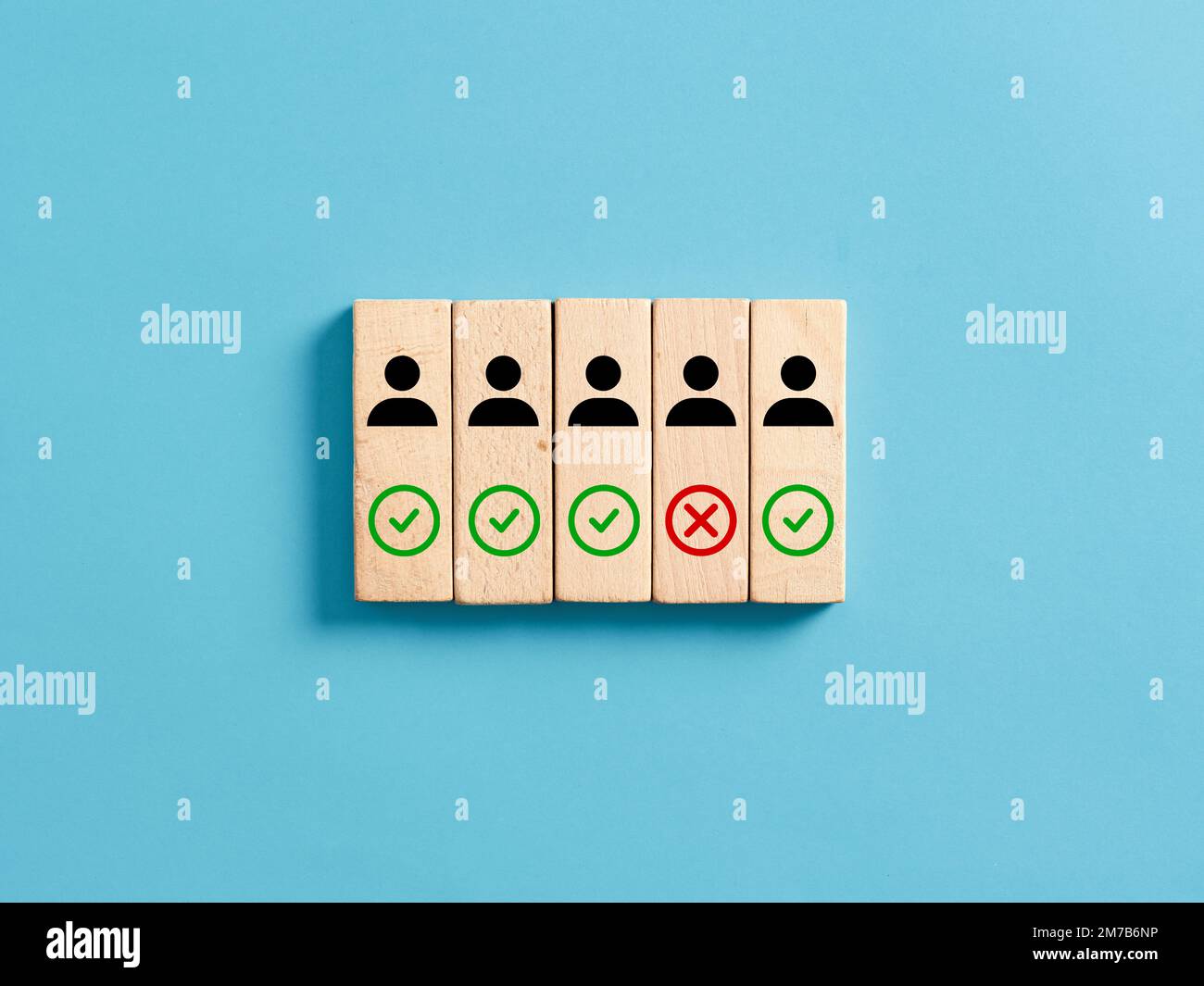 Firing and employee. Termination of job contract. Job dismissal or discharge. Candidate rejection. Employee, checkmark and cross icons on wooden block Stock Photo