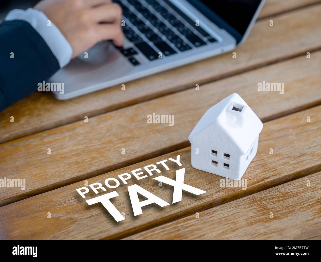 Home tax, refinance, house mortgage, loan, investment housing real estate interest rates concepts. The 3d word 'PROPERTY TAX' and miniature house on d Stock Photo