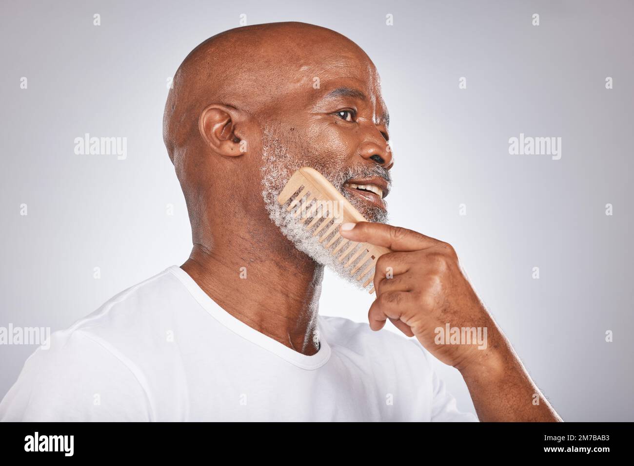 Elderly, black man with comb for beard, beauty and grooming with hygiene  and cosmetic care against studio background. Hair care mockup, brush body  Stock Photo - Alamy