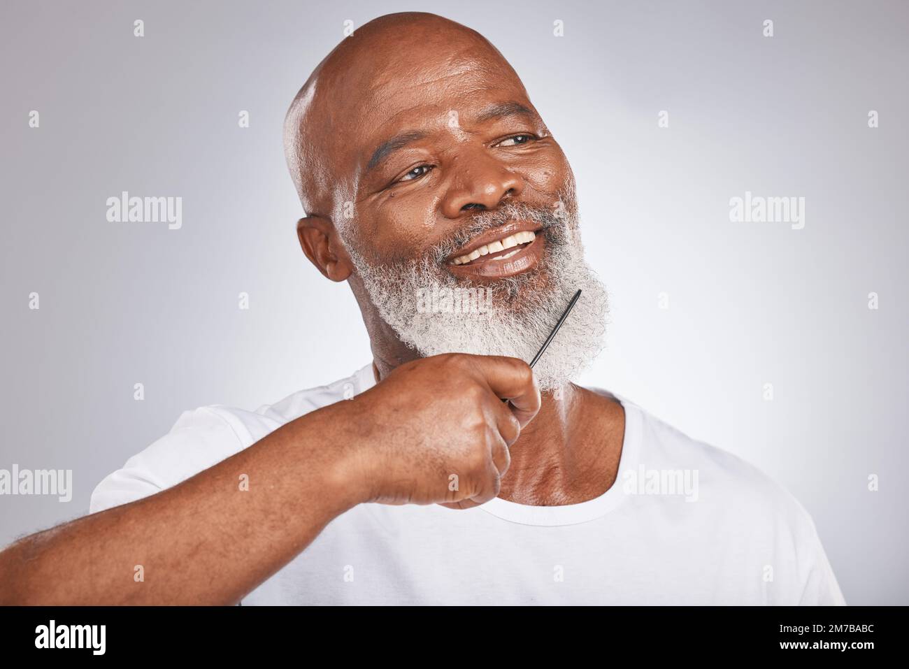 Elderly, black man with comb for beard, beauty and grooming with hygiene  and cosmetic care against studio background. Facial hair mockup, brush body  Stock Photo - Alamy