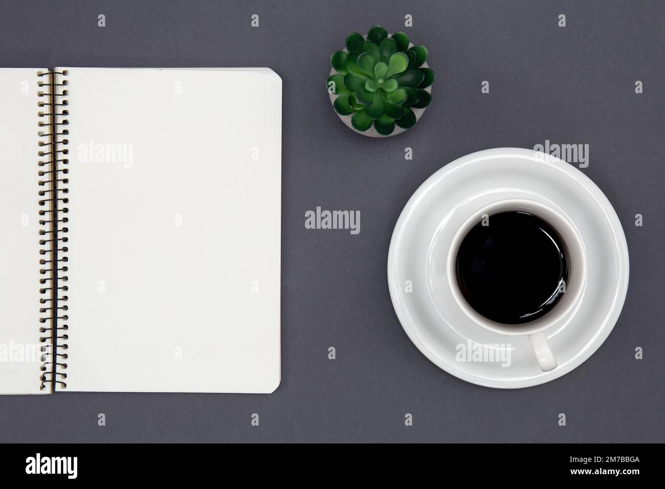 Blank notepad and coffee cup, conceptual minimalism. Stock Photo