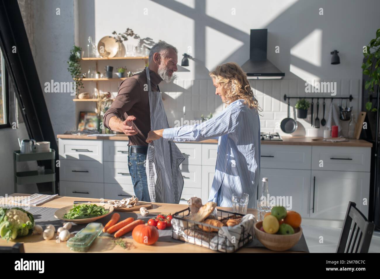 Mature couple feeling good while cooking together in the kitchen Stock ...
