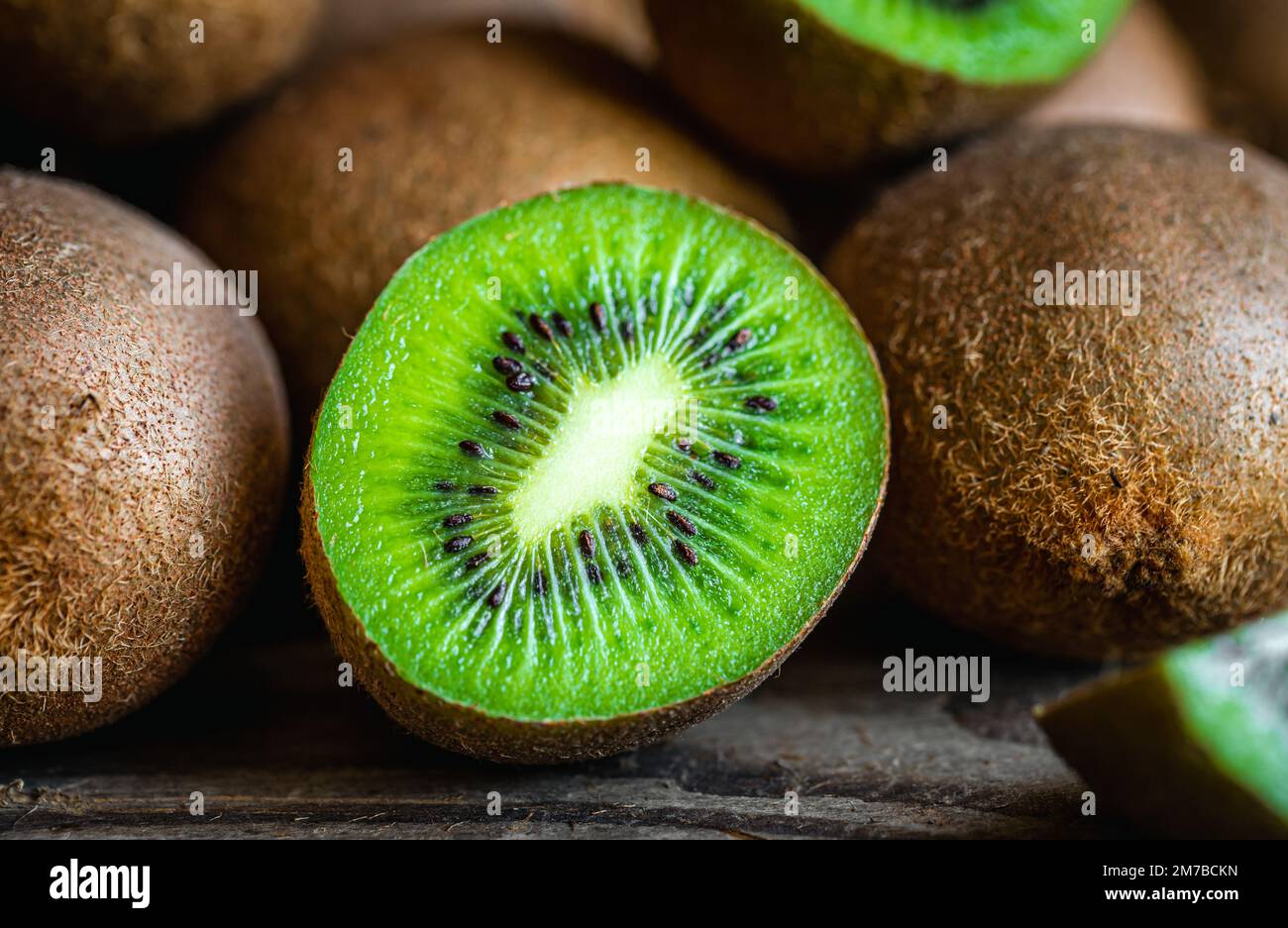 Ripe fruits of kiwi cut and whole, close -up Stock Photo - Alamy