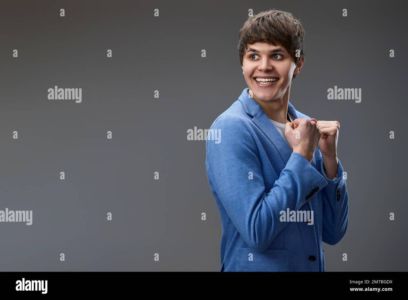 Excited young man holding fists hi-res stock photography and images - Alamy