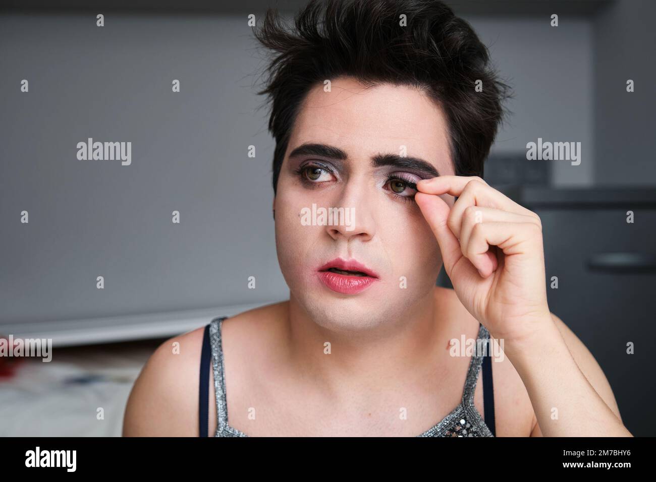 Young drag queen removing false eyelashes Stock Photo Alamy