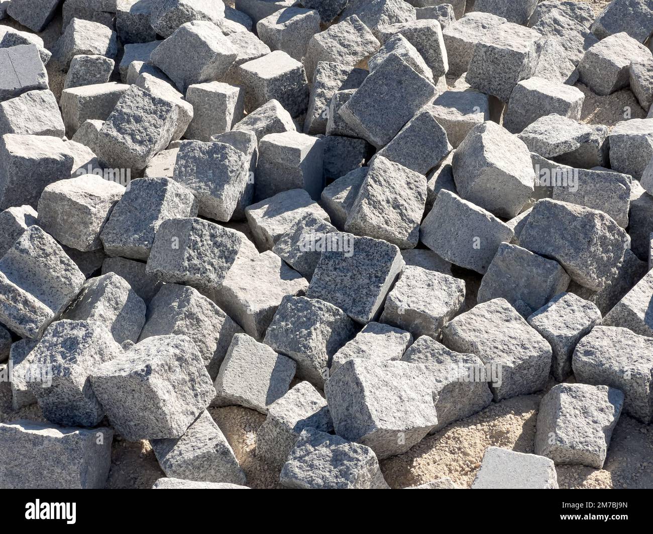 heap of cobblestones background, paving stone building material at construction site Stock Photo