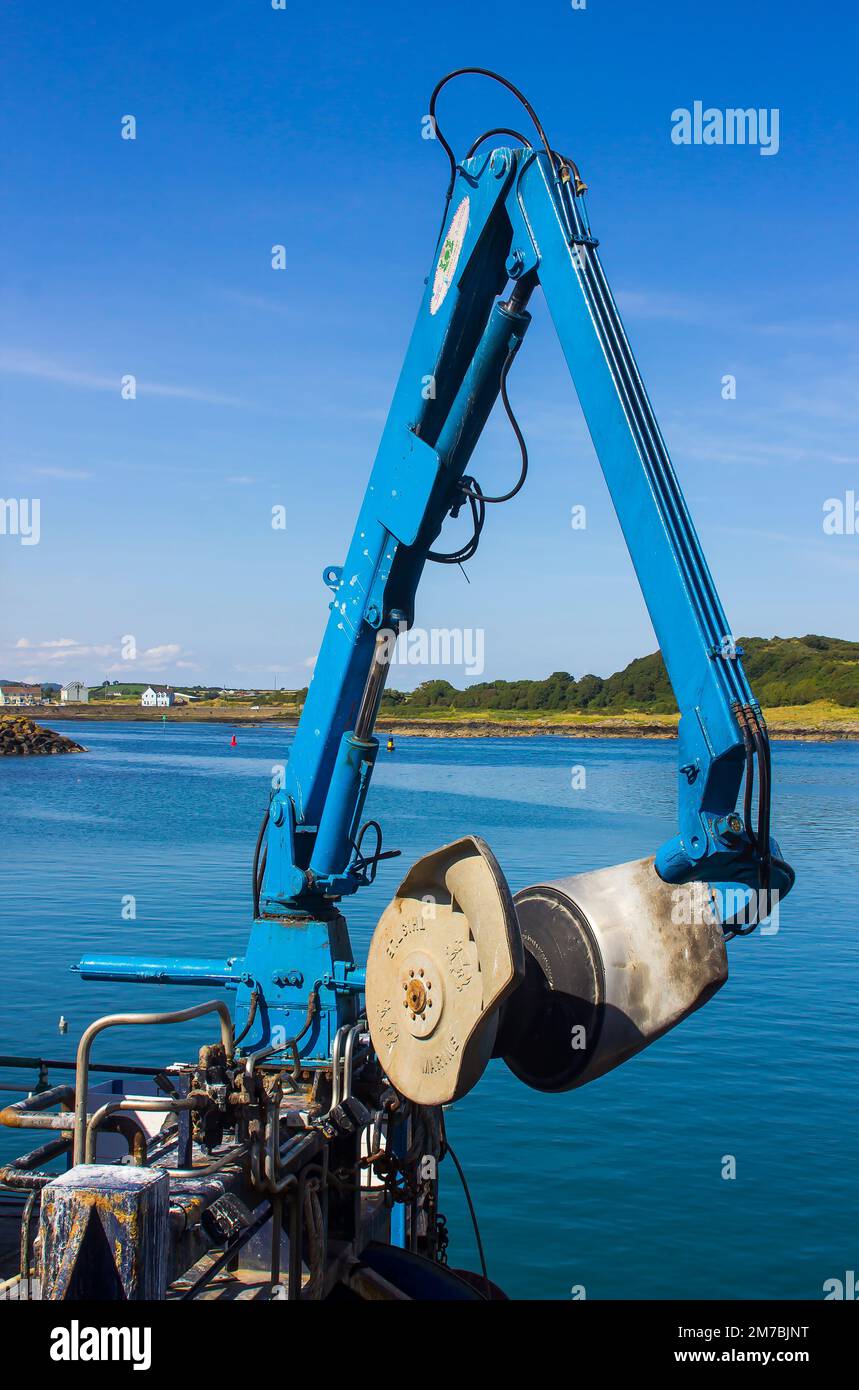 8 August 2019 A hydraulic flexible net boom arm on a small trawler berthed at Ardglass Harbour in County Down Northern Ireland Stock Photo