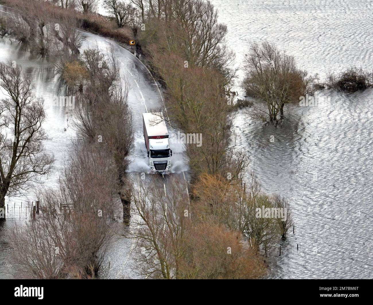 The Welney wash fills with floodwater and the road is becoming flooded as the levels of The Old Bedford river and River Delph rise after recent rain, in Welney, Cambridgeshire, on January 5, 2023. Stock Photo