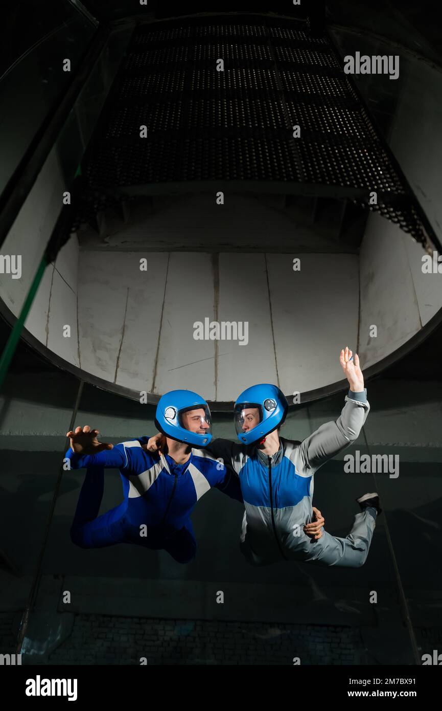 A man and a woman enjoy flying together in a wind tunnel. Free fall ...