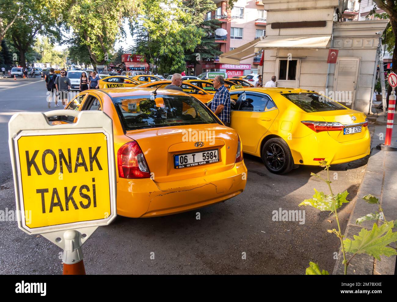 Ankara transportation. Yellow taxi cabs on a taxis stop with a poster