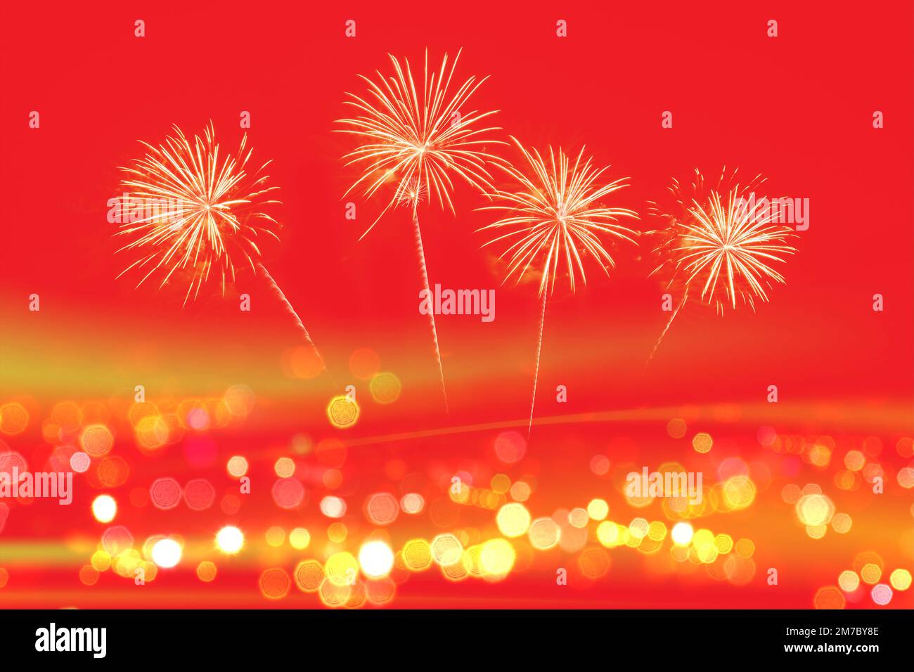 Gold fireworks celebration on red background with copy space for Chinese new year celebration. Stock Photo