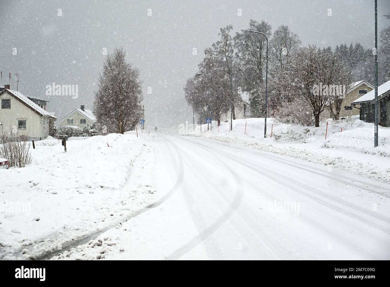 The main street of the village of Strand during a snow storm, far northern Norway. Stock Photo