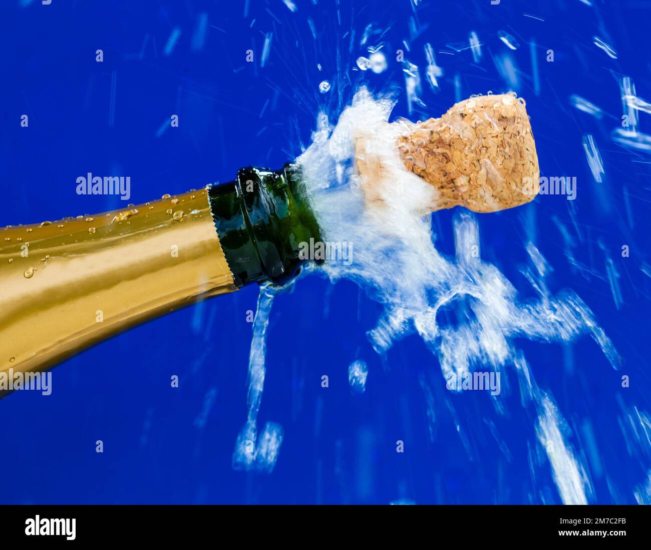 cork shooting out of a champagne bottle, popping the corks Stock Photo