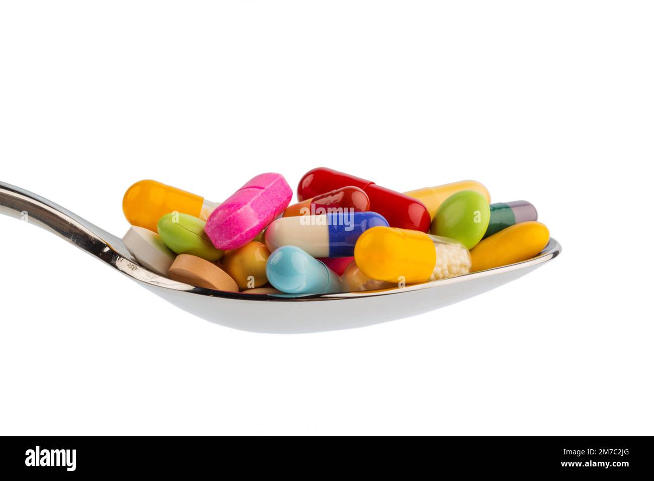 colourful pills on a spoon, cutout Stock Photo