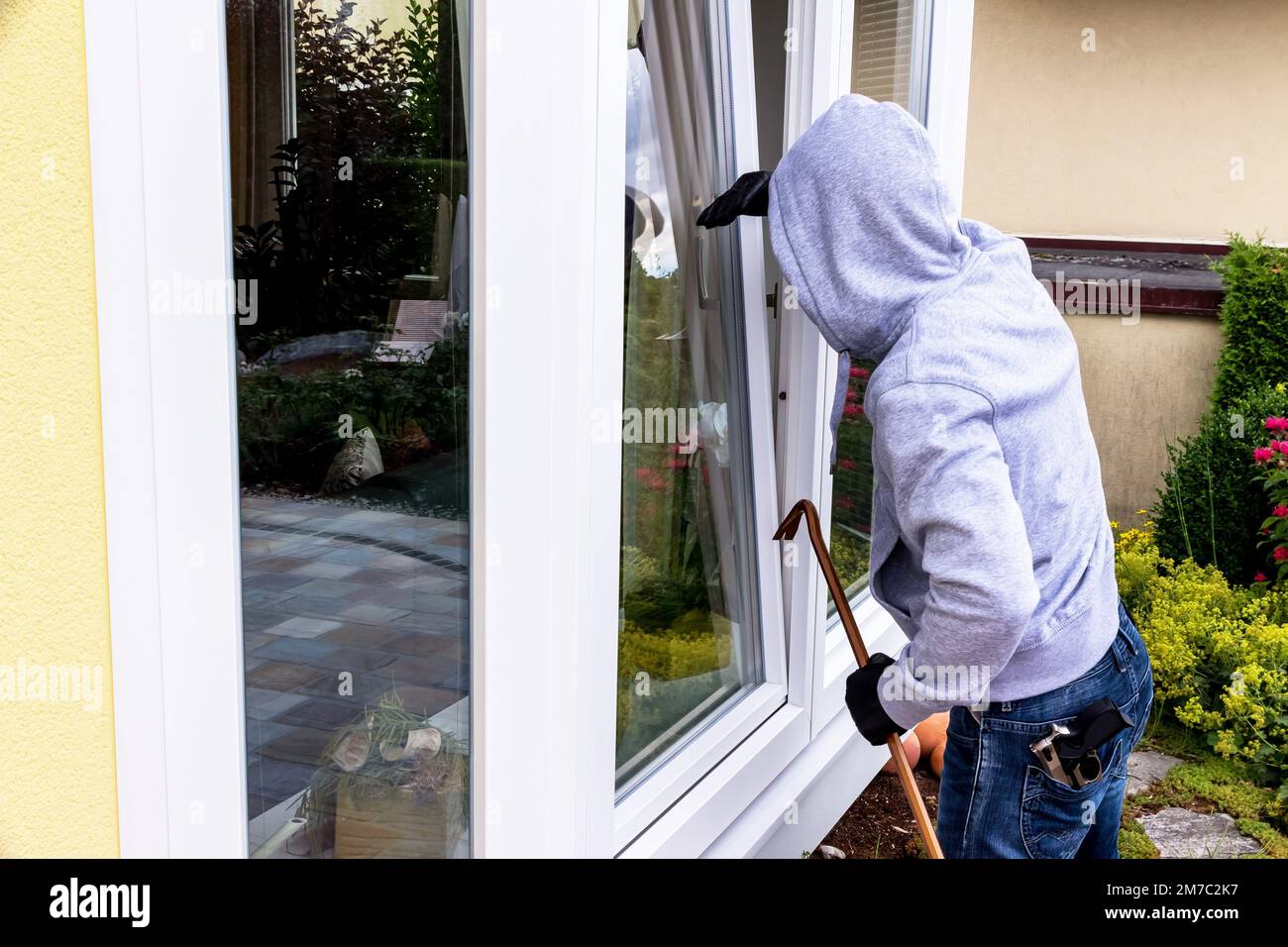 thief with prybar and torch light at an open window Stock Photo - Alamy