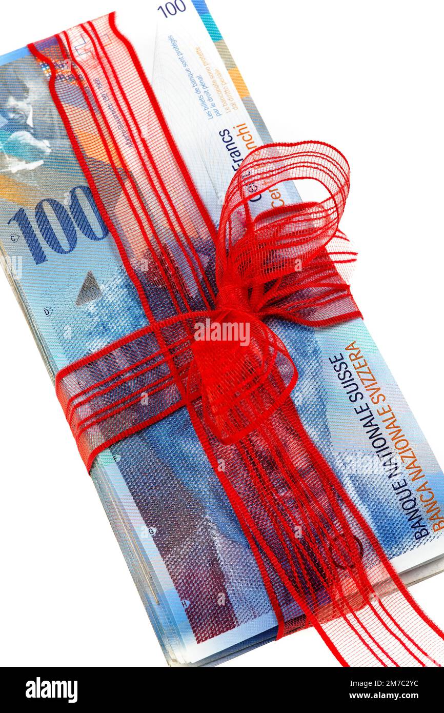 Swiss francs with a red bow as a Christmas gift, gift of money Stock Photo
