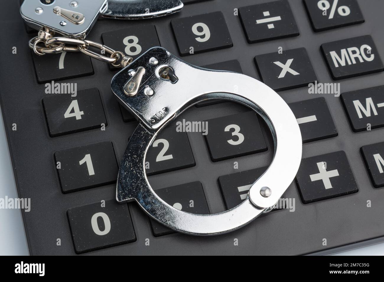 calculator with handcuff Stock Photo
