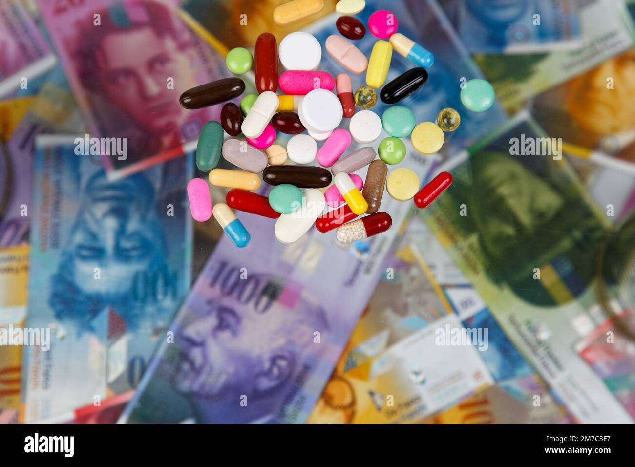 colourful pills on Swiss francs, cutout Stock Photo