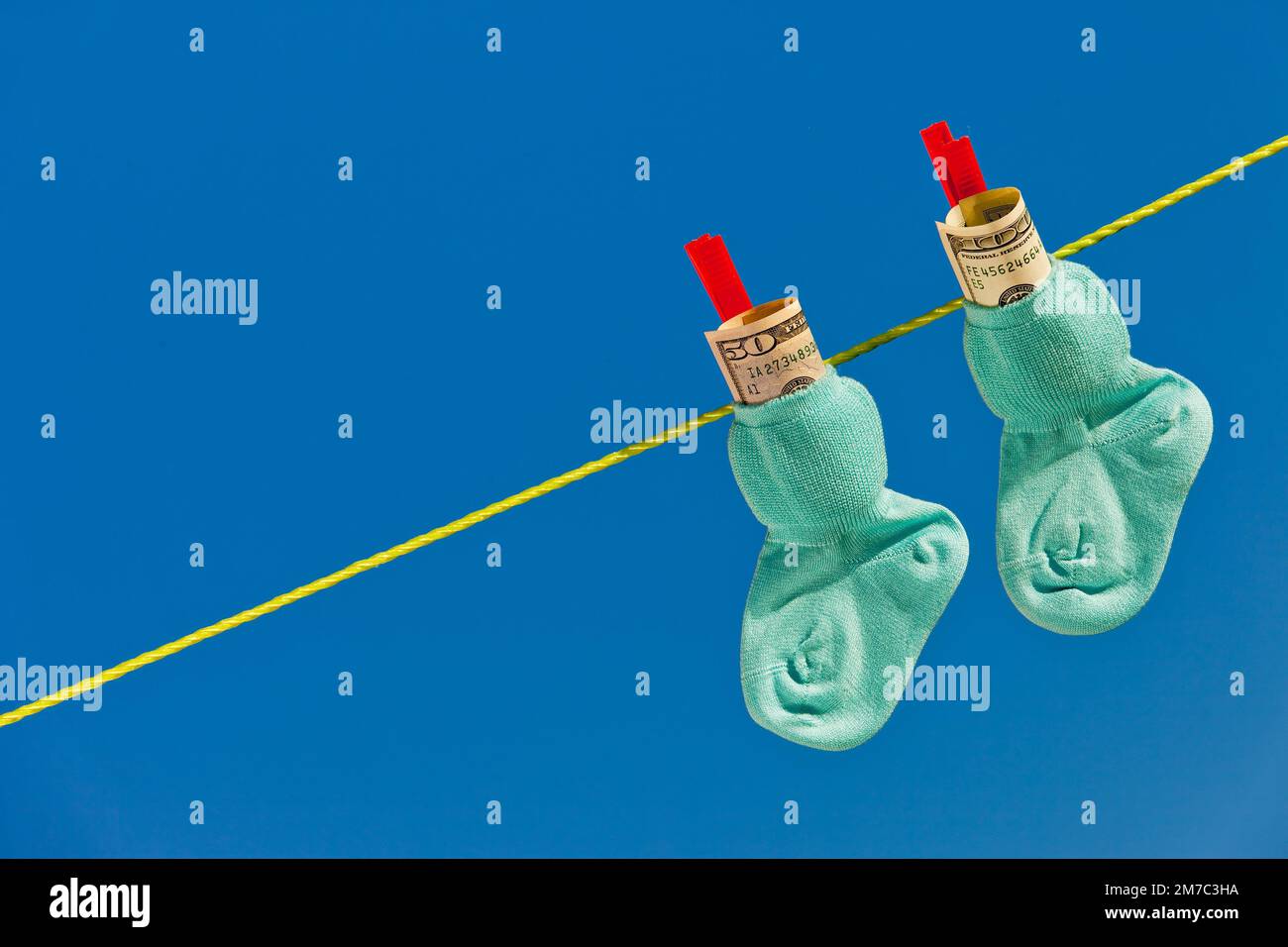 baby's socks with Dollar bills on clothesline, USA Stock Photo Alamy