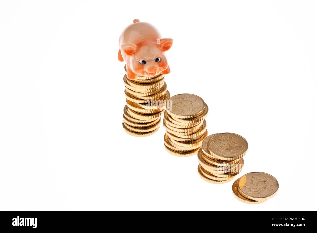piggy bank standing on a stack of fifty cent coins, front view Stock