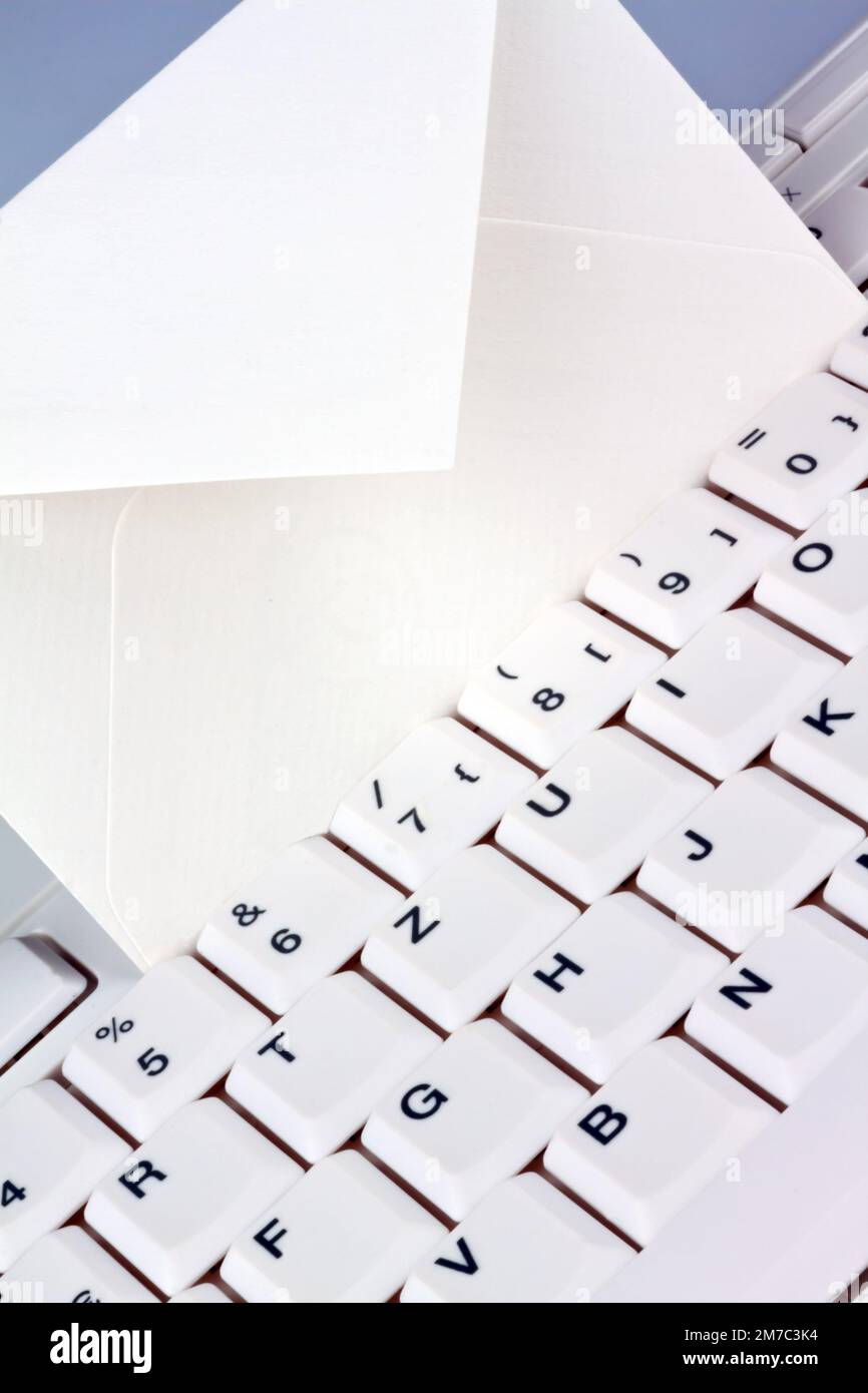 empty envelope on a white keyboard, snail-Mail versus e-mail Stock Photo