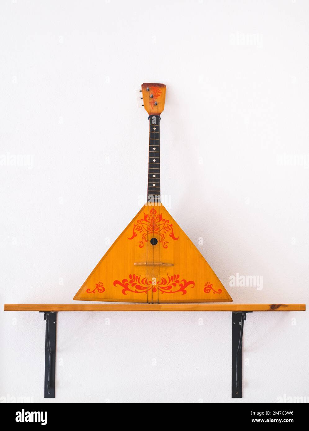 Balalaika is a Russian stringed musical instrument with a characteristic  wooden triangular hollow body, fretted neck and three strings Stock Photo -  Alamy