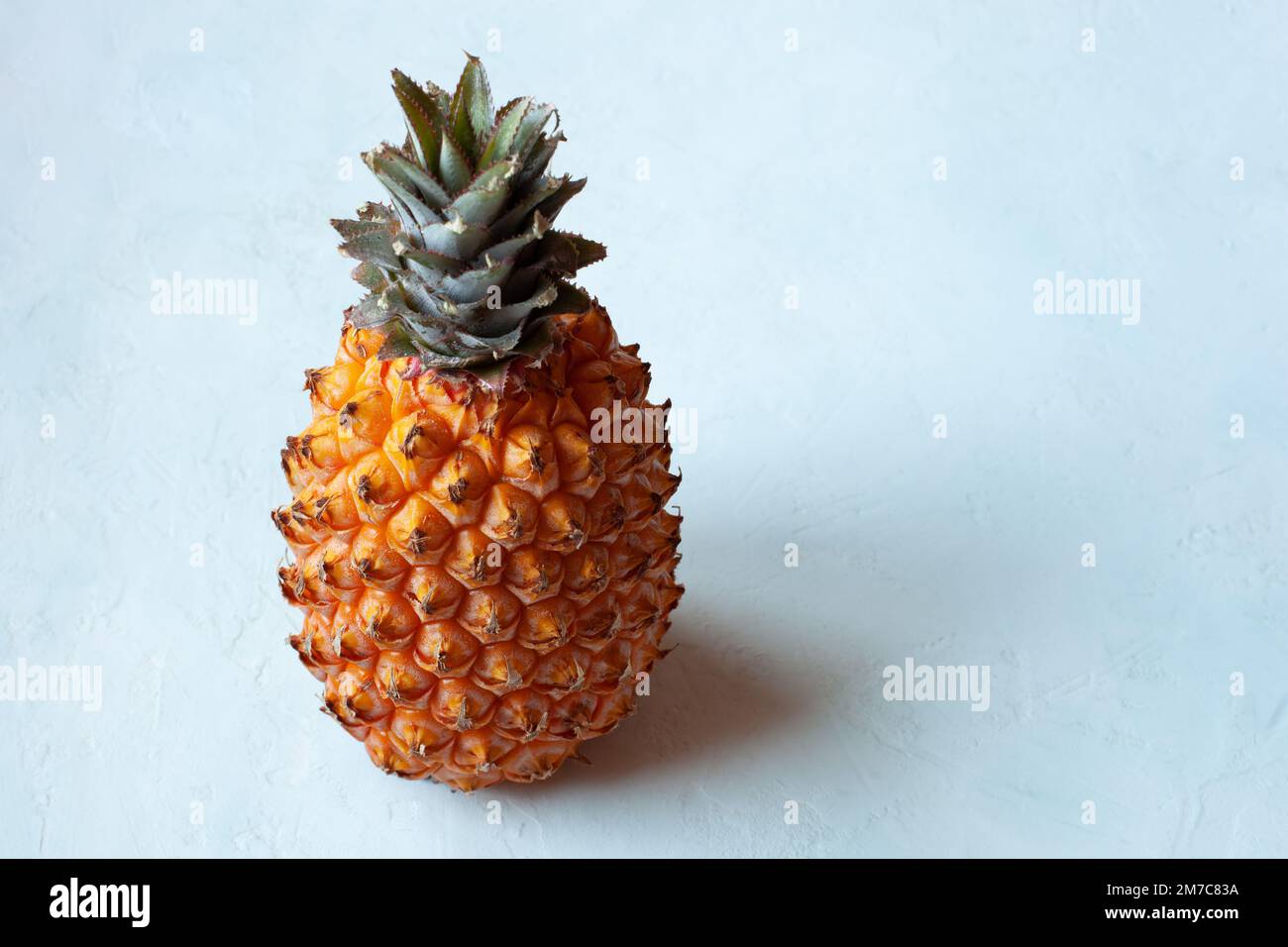 whole pineapple fruit on the light blue background Stock Photo - Alamy