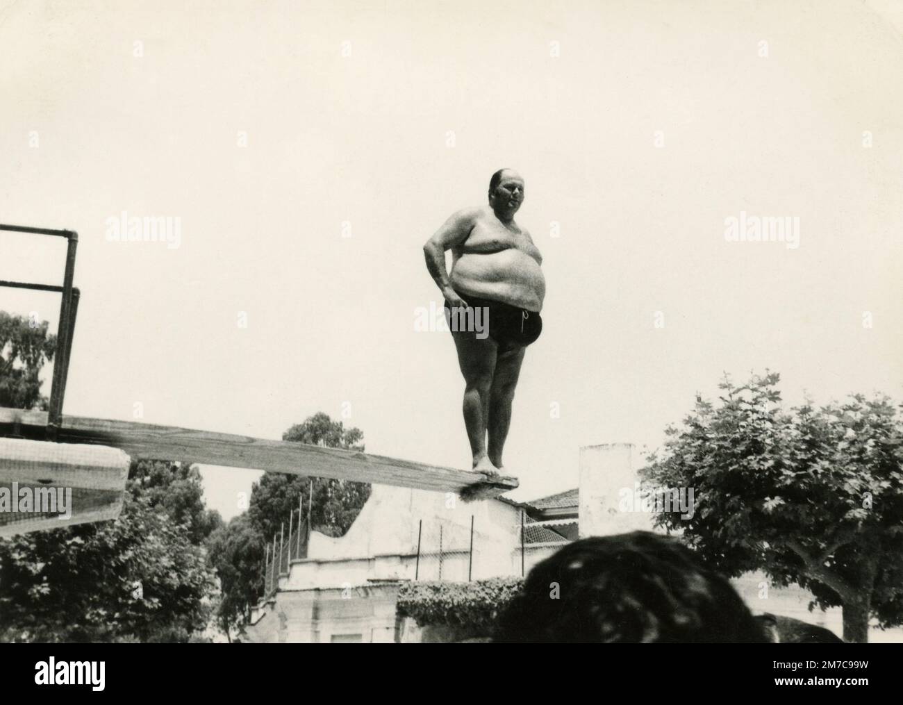 Fat man on a diving board, Italy 1972 Stock Photo