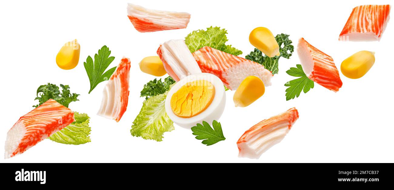 Falling crab sticks salad ingredients isolated on white background Stock Photo