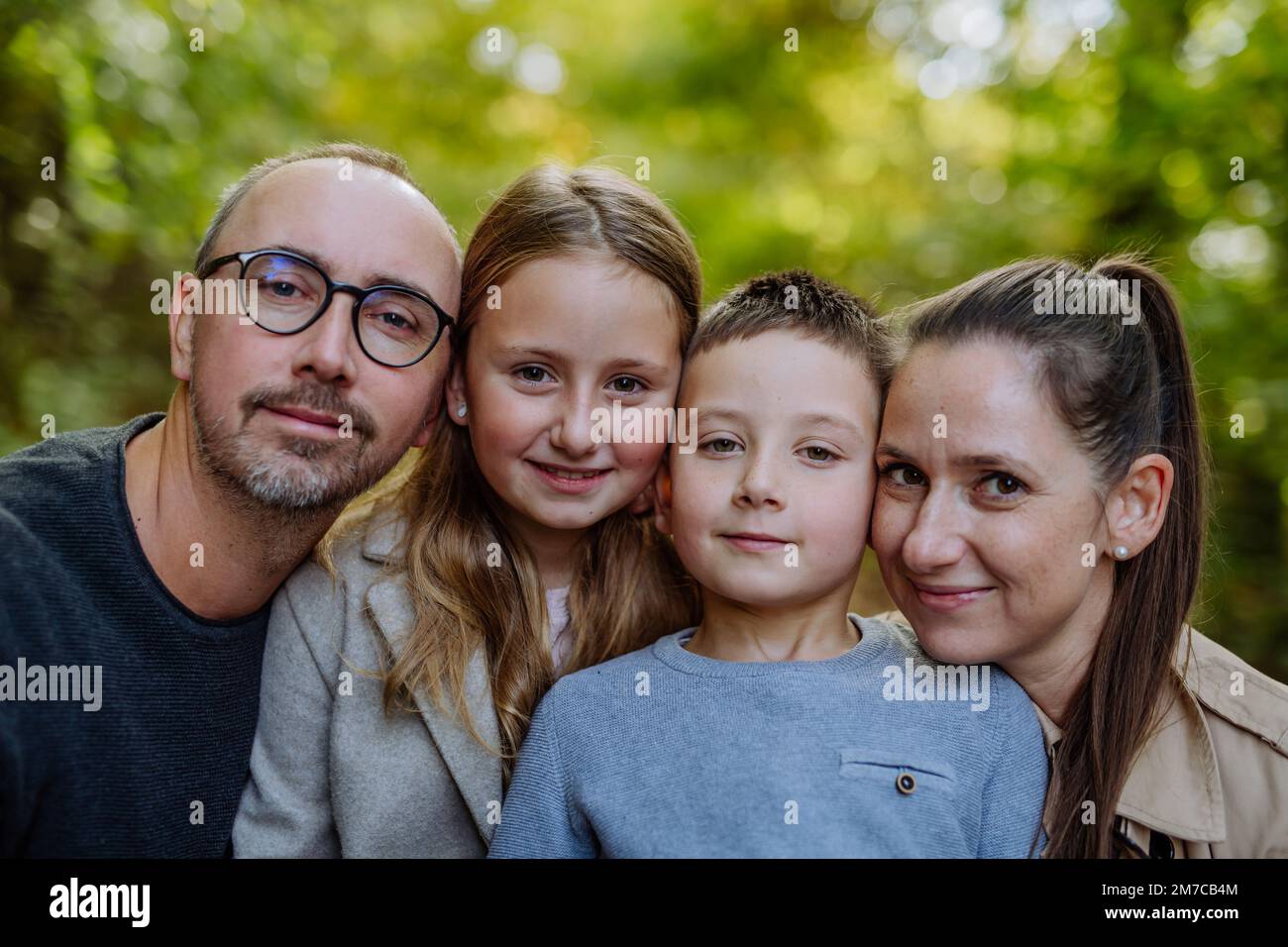 Portrait of happy family with kids in a forest. Stock Photo