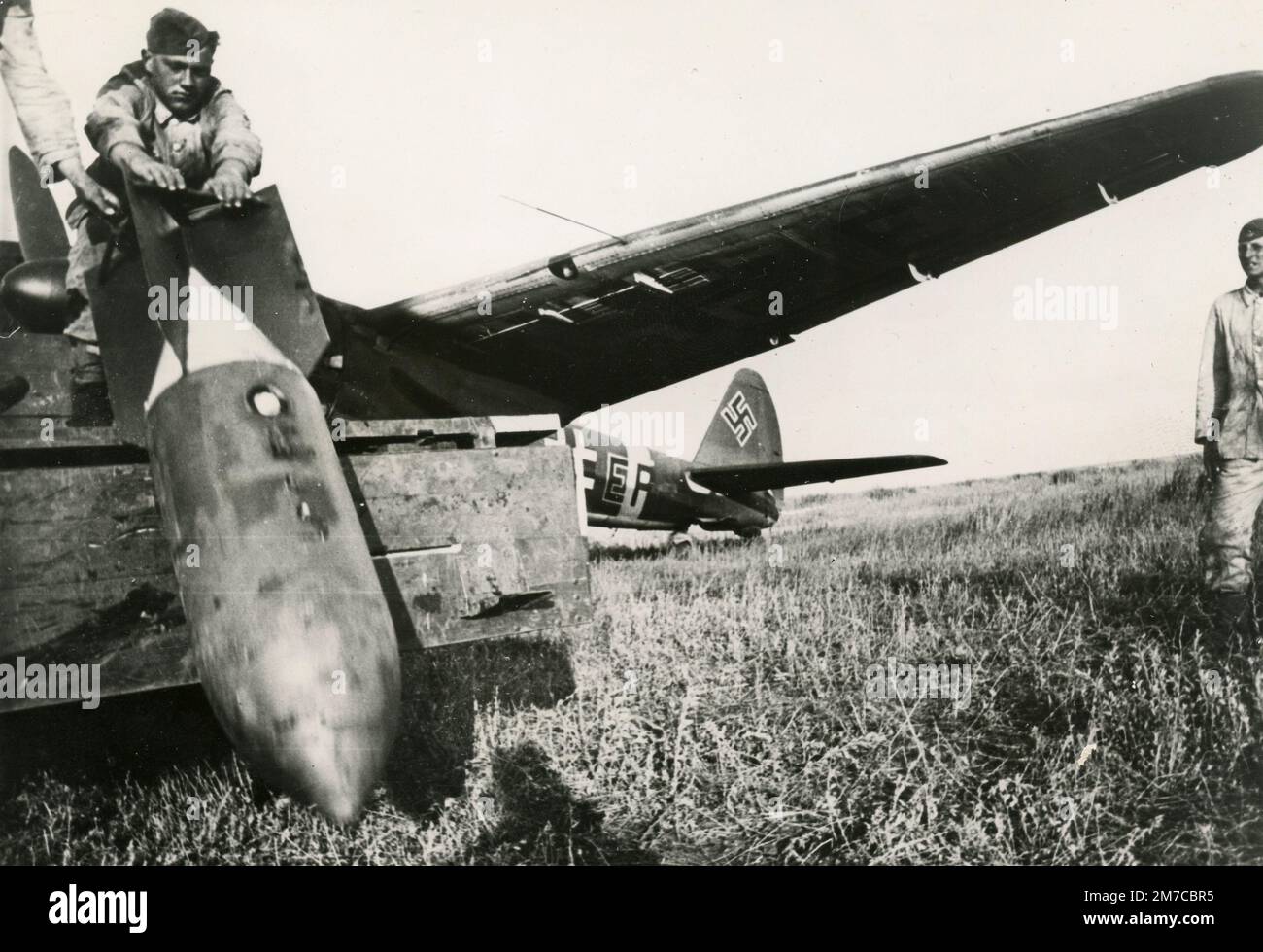 German soldiers loading the SC 500 or cylindrical explosive bomb on the