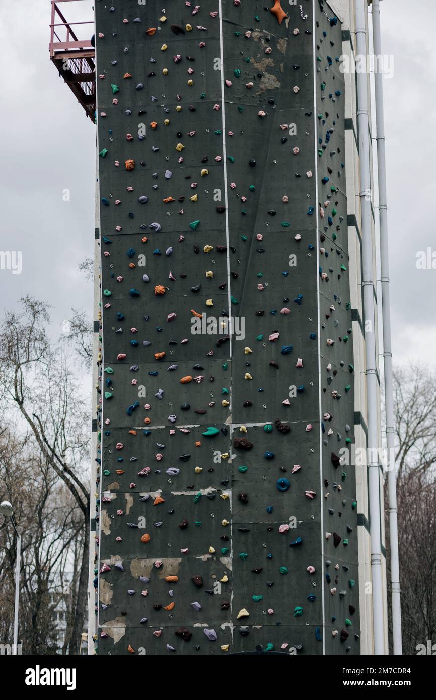 Outdoor climbing rock tower. Street artificial rock climbing wall Stock Photo