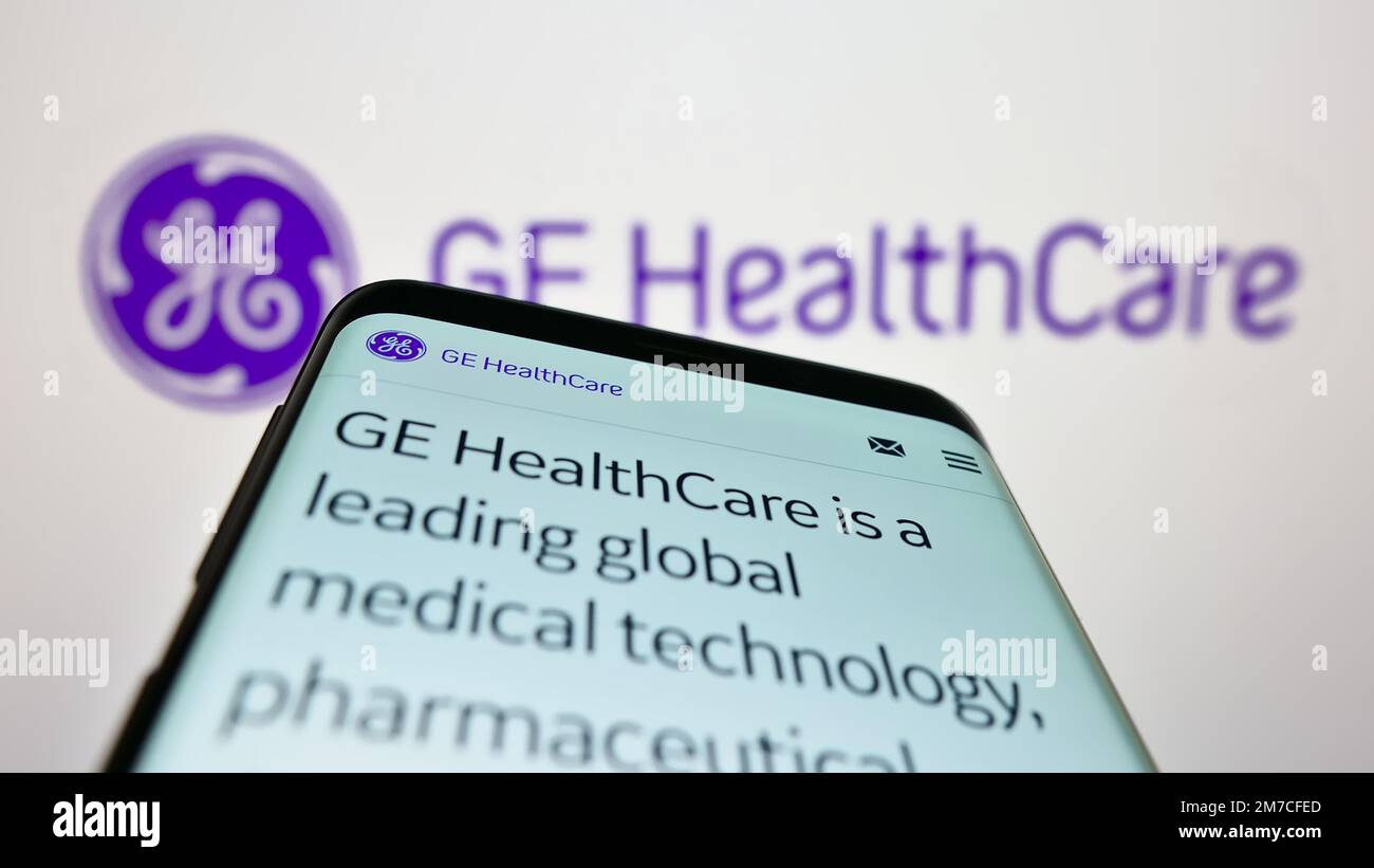 Smartphone with webpage of US company GE HealthCare Technologies Inc. on screen in front of business logo. Focus on top-left of phone display. Stock Photo