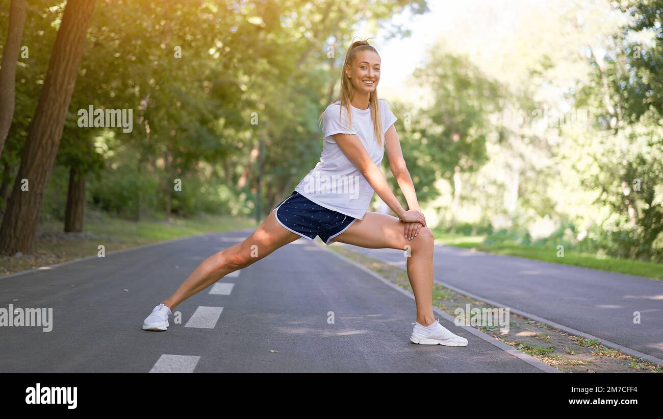 Premium Photo  Girl athlete does warmup on legs before physical exertion  workout on the street site