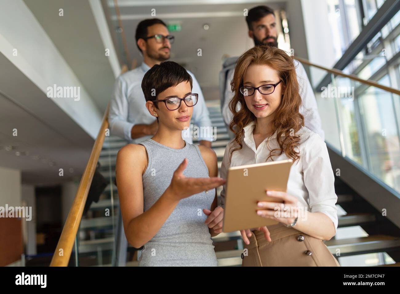 Portrait of two happy success business women talking, having informal meeting in office Stock Photo