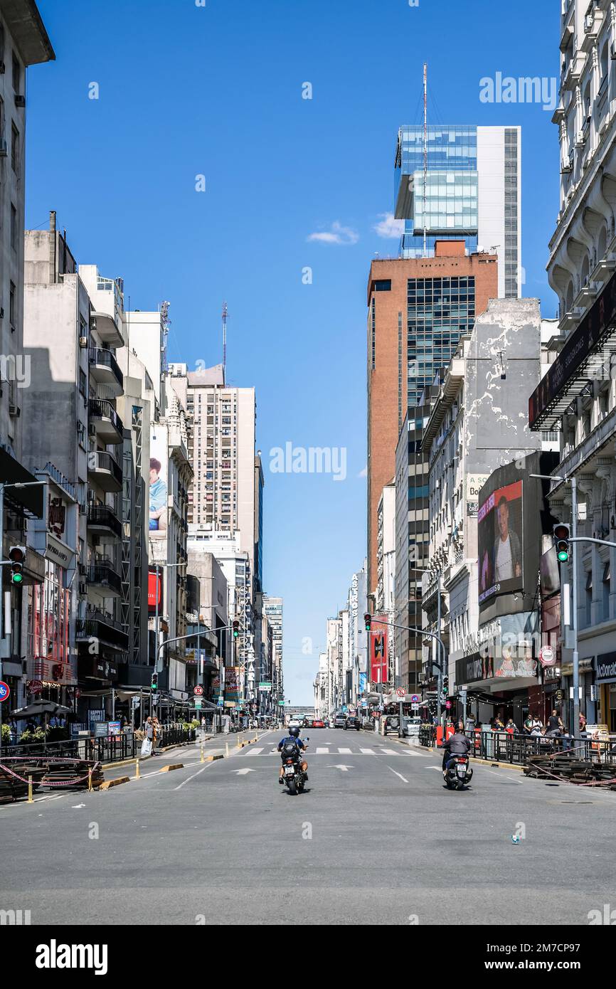 Buenos Aires, Argentina - January 2, 2023: A busy street in the central area of Buenos Aires with public transport and traffic. Street life, urban city concept. High quality photo Stock Photo